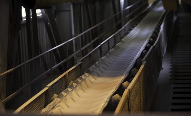 Close up of conveyor belt with white cloth. Stock footage. Industrial background inside the workshop of the factory and moving conveyor belt with narrow stripe of white fabric. Close up of conveyor belt with white cloth. Industrial background inside the workshop of the factory and moving conveyor belt with narrow stripe of white fabric.